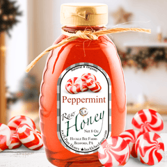 Bottle of peppermint honey with candy canes on a blurred background