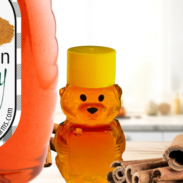 Cinnamon Honey: Nature’s Perfect Pairing with 100% Pure Honey in a bear-shaped bottle, surrounded by cinnamon sticks on a kitchen counter.