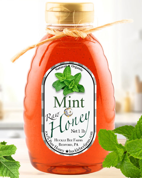 Mint Infused Honey in a 1 lb jar with a natural twine bow, featuring a rich amber color and fresh mint leaves, perfect for teas and desserts.