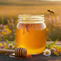 Jar of golden honey with bees and wildflowers at Huckle Bee Farms