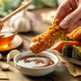 Homemade garlic honey sauce in a glass jar with garlic cloves and honey dipper on a rustic wooden table – Huckle Bee Farms Garlic Honey recipe.