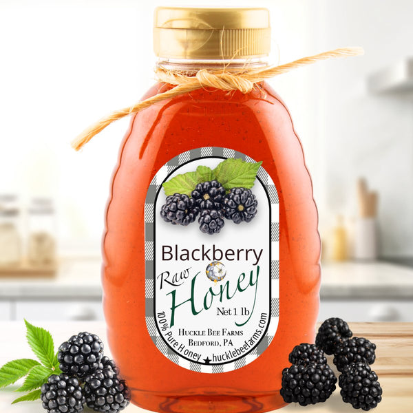 Blackberry raw honey in a 1 lb jar from Huckle Bee Farms. Rich amber-colored honey with fresh blackberries, perfect for teas, desserts, and more.