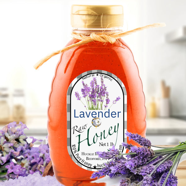 Lavender raw honey in a 1 lb bottle with a rustic twine bow. Featuring a natural, organic label with lavender flowers, set against a floral backdrop.