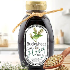 Raw buckwheat honey in a 1 lb bottle with a natural rope tie, featuring a rich dark color. Perfect for sweetening tea or enhancing recipes.