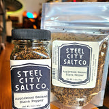 Applewood Smoked Black Pepper by Steel City Salt Co. in jar and resealable pouch. Bold flavor spice for BBQ, steak, seafood, and vegetables.