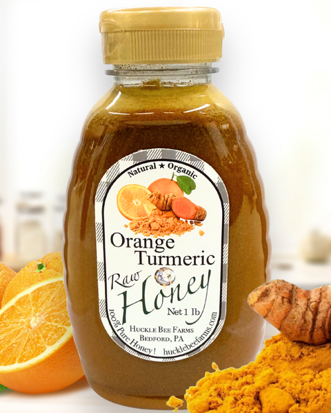 Golden jar of Huckle Bee Farms Orange Turmeric Honey with fresh orange slices and turmeric roots — immune boosting, anti-inflammatory honey blend.