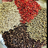 Four Peppercorn Blend featuring Tellicherry black, white, green, and pink peppercorns in a vibrant, aromatic mix for gourmet seasoning.