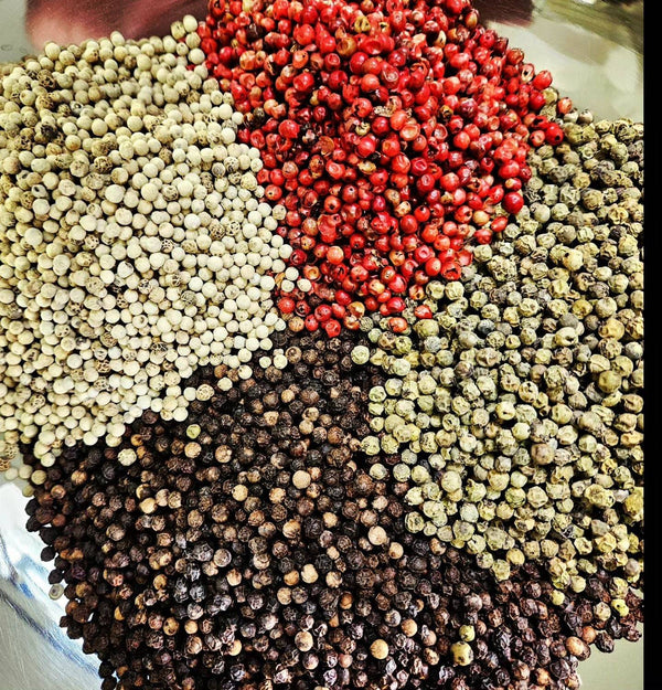 Four Peppercorn Blend featuring Tellicherry black, white, green, and pink peppercorns in a vibrant, aromatic mix for gourmet seasoning.
