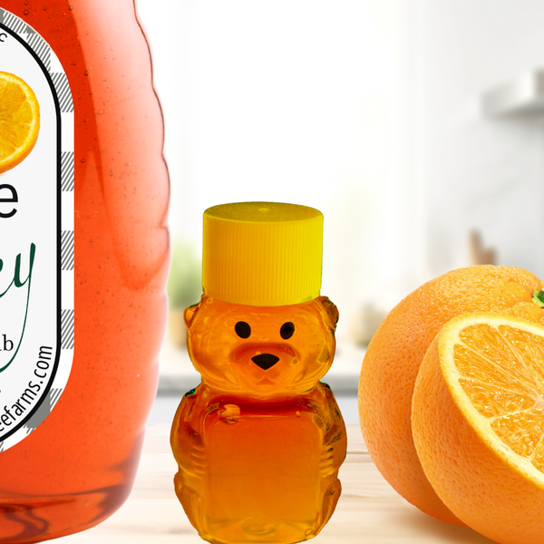 Orange honey jar with a bear-shaped honey bottle and fresh oranges on a kitchen counter. A delightful fusion of pure honey and citrus flavor.