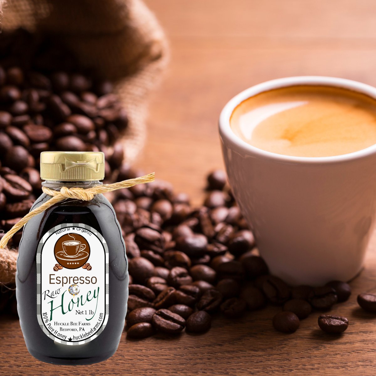 Bottle of Espresso Honey with a cup of coffee and coffee beans on a wooden surface