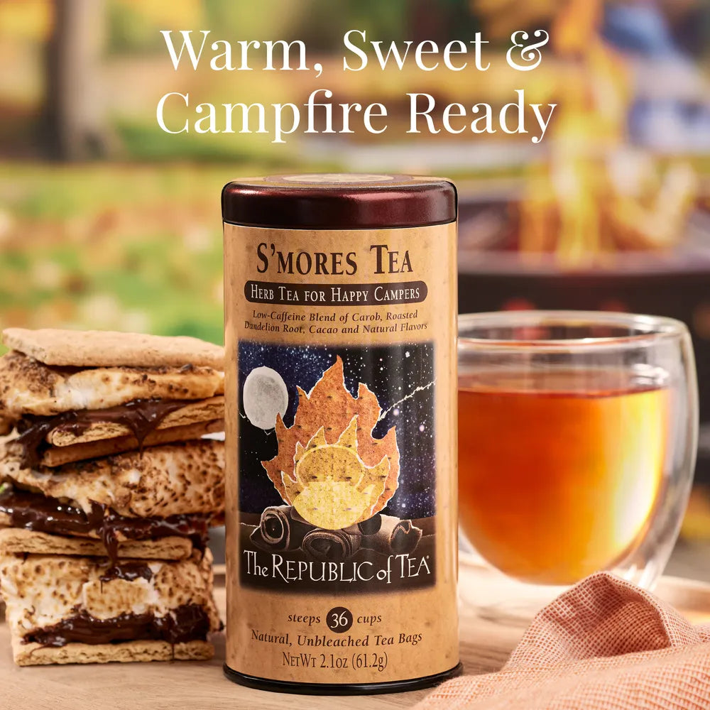 S'mores tea packaging with a cup of tea and s'mores in the background