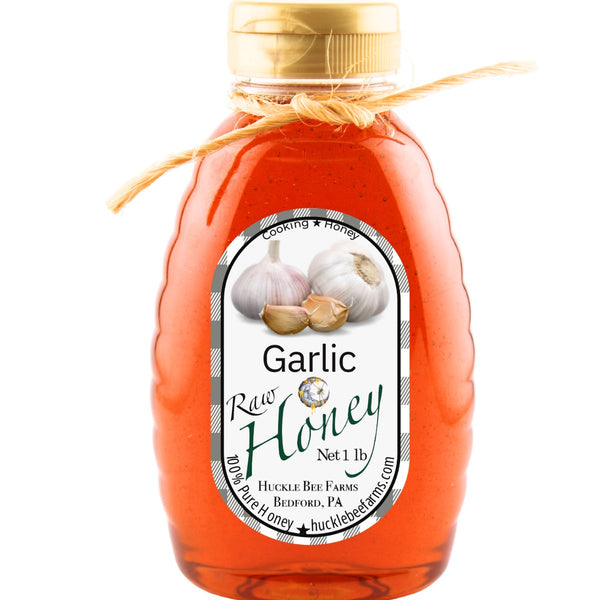 Pure garlic-infused raw honey in a 1 lb bottle, crafted for cooking and enhancing dishes with a natural, flavorful sweetness.