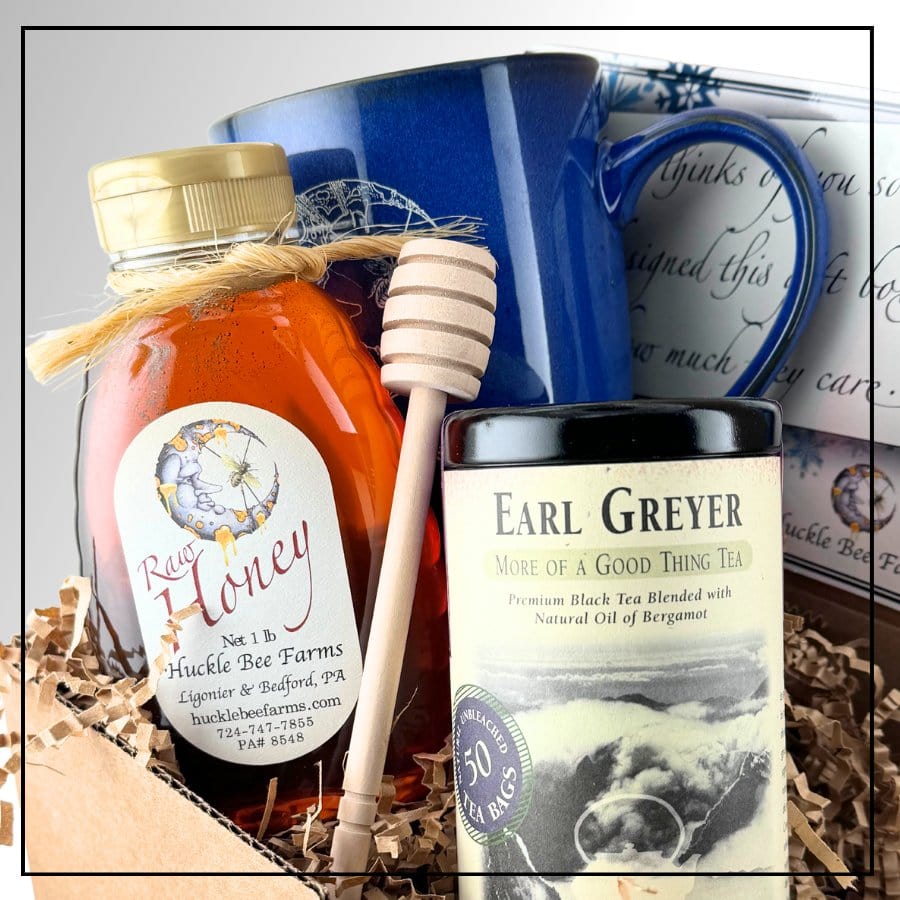 Tea gift set featuring honey, mug, and Earl Grey tea