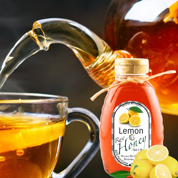 Lemon honey bottle next to a steaming cup of tea, highlighting its use as a natural sweetener for a refreshing and healthy beverage.