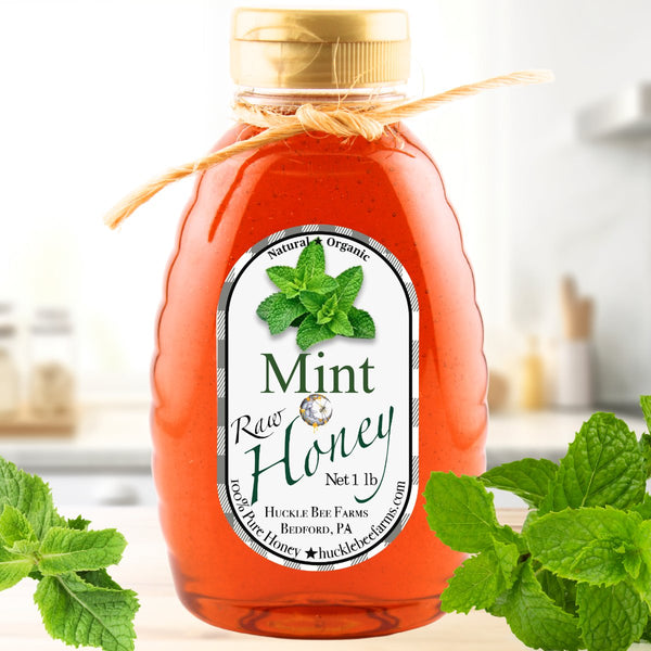 Mint Infused Honey in a 1 lb jar with a natural twine bow, featuring a rich amber color and fresh mint leaves, perfect for teas and desserts.