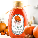 Pumpkin honey in a bottle with warm autumn tones, infused with cozy pumpkin spice flavor, perfect for fall drinks and baked goods.