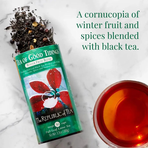 Tea of Good Tidings - Winter Fruit Blend loose tea spilling from a tin, showcasing a rich mix of black tea, fruit, and spices.