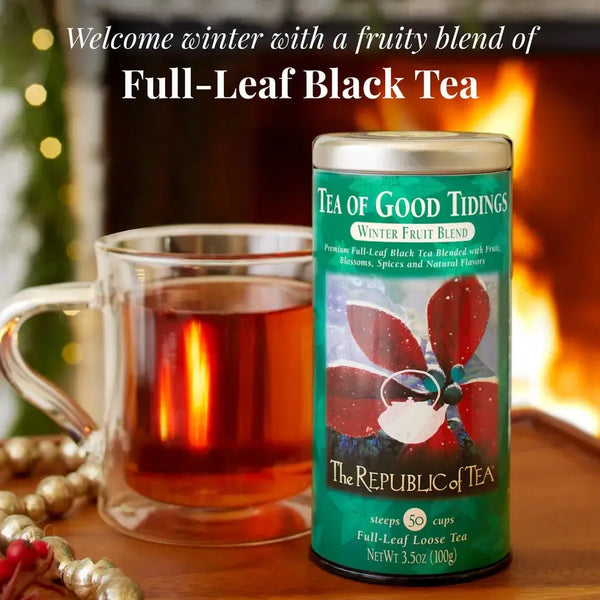 Tea of Good Tidings - Full-Leaf Black Tea Blend in a decorative tin beside a warm cup of tea, perfect for the holiday season.