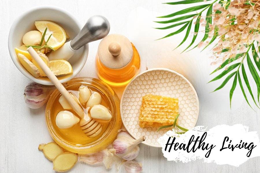 Garlic honey with fresh garlic and a honey dipper