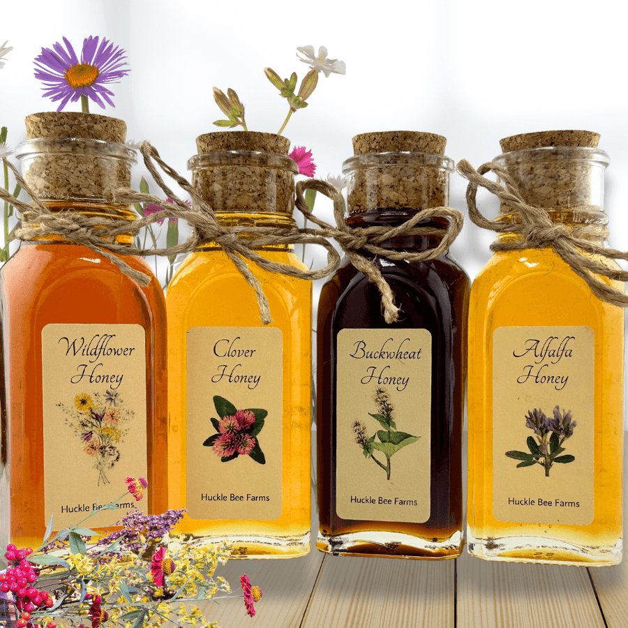 Four bottles of Huckle Bee Farms honey with flowers