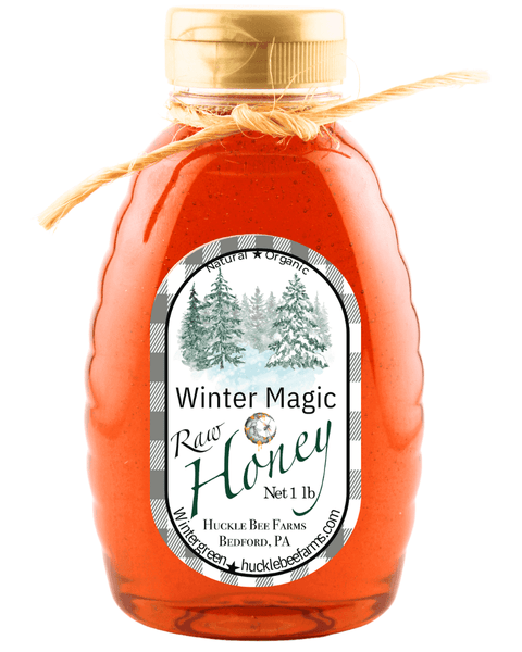 Winter Magic Honey by Huckle Bee Farms LLC in a 1lb jar with a natural twine bow, featuring raw honey and a winter-themed label.