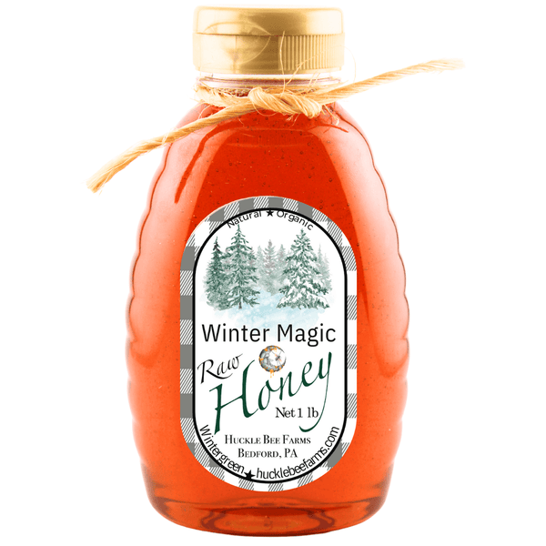 Winter Magic Honey by Huckle Bee Farms LLC in a 1lb jar with a natural twine bow, featuring raw honey and a winter-themed label.